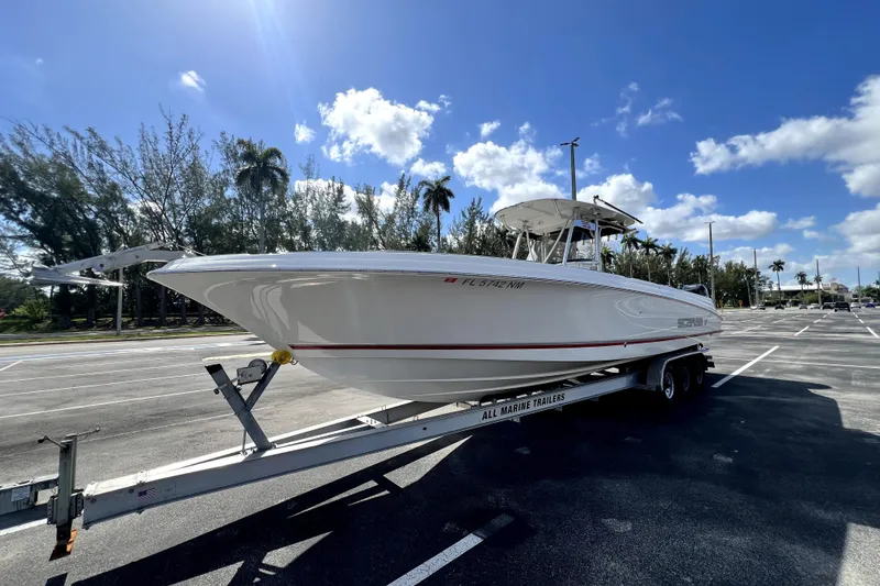 Slide: The Image of 2007 Wellcraft 35 Scarab Sport Open boat on trailer under clear blue sky. - 18