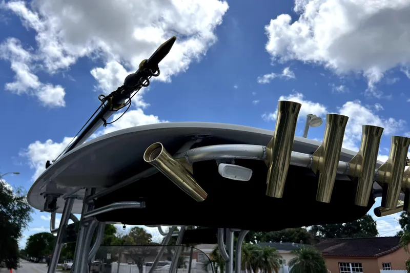 Slide: The Image of 2007 Wellcraft 35 Scarab Sport Open boat with rod holders against a cloudy sky. - 32