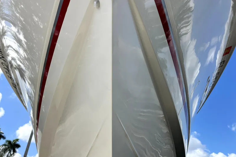 Slide: The Image of 2007 Wellcraft 35 Scarab Sport Open boat hull against blue sky. - 19