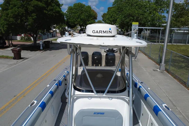 Slide: The Image of 2007 Wellcraft 35 Scarab Sport Open boat with Garmin equipment, parked on a street. - 116