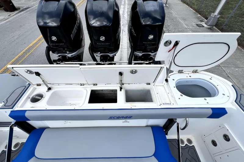 Slide: The Image of 2007 Wellcraft 35 Scarab Sport Open boat with triple Mercury outboard engines and open storage compartments. - 28