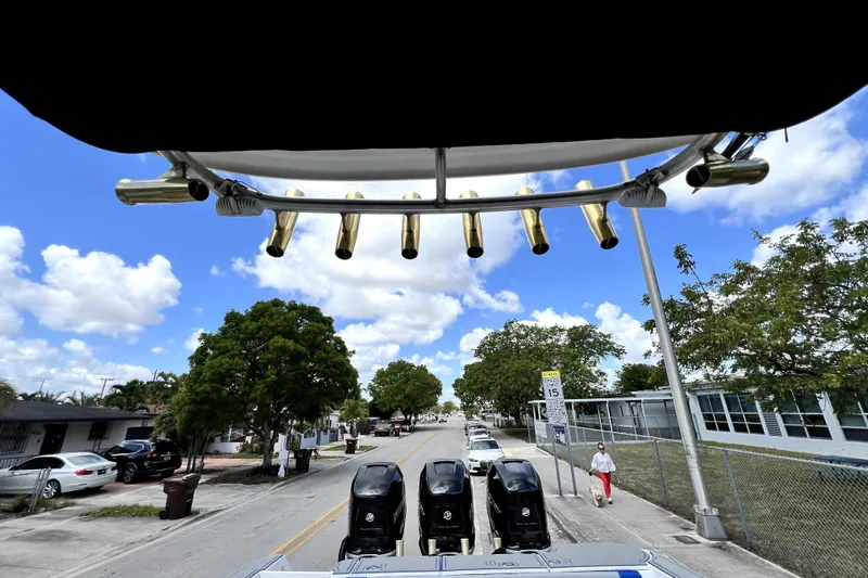 Slide: The Image of 2007 Wellcraft 35 Scarab Sport Open with triple engines on a sunny street. - 72