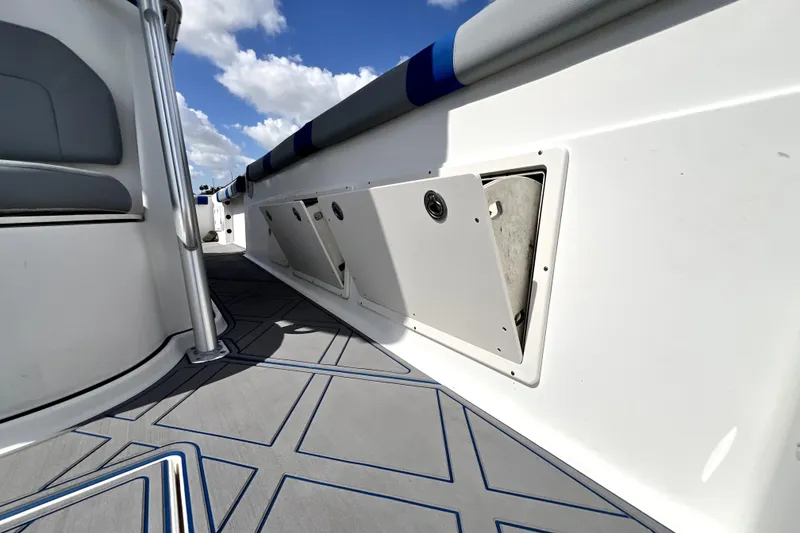 Slide: The Image of 2007 Wellcraft 35 Scarab Sport Open boat interior with storage compartments and cushioned seating. - 95