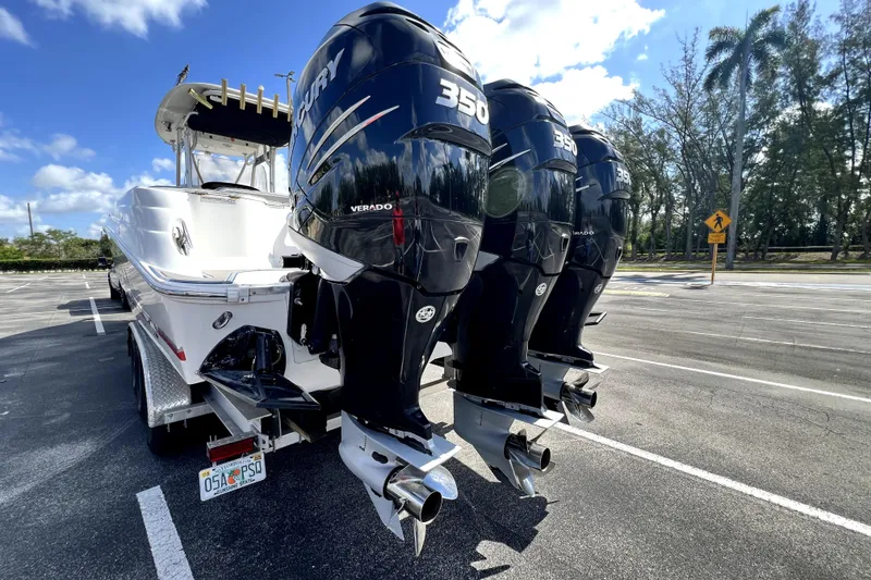 Slide: The Image of 2007 Wellcraft 35 Scarab Sport Open with triple Mercury 350 engines in a parking lot. - 14