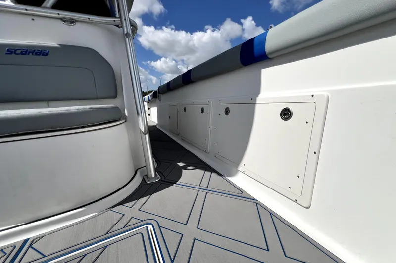 Slide: The Image of 2007 Wellcraft 35 Scarab Sport Open boat interior with sleek seating and storage compartments. - 89