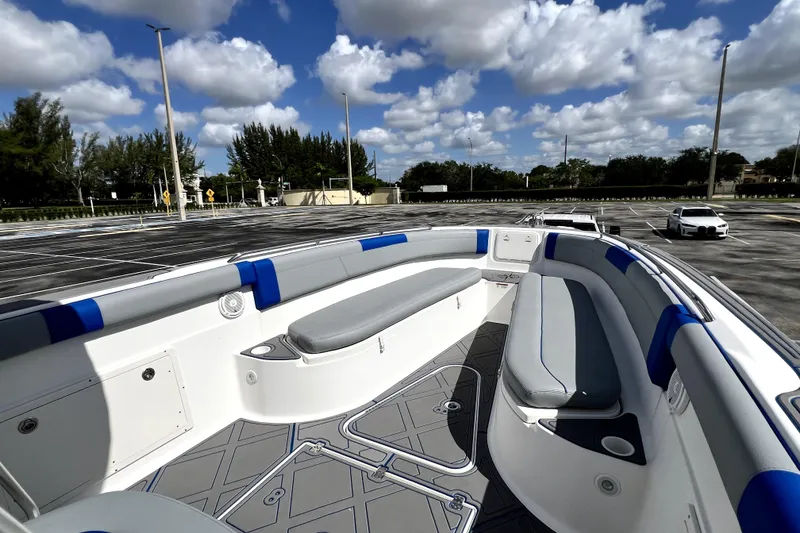 Slide: The Image of 2007 Wellcraft 35 Scarab Sport Open boat interior with cushioned seating under a cloudy sky. - 77
