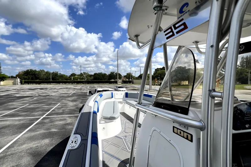 Slide: The Image of 2007 Wellcraft 35 Scarab Sport Open boat in parking lot under blue sky. - 83