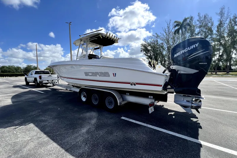 Slide: The Image of 2007 Wellcraft 35 Scarab Sport Open boat on trailer, parked in sunny lot. - 16