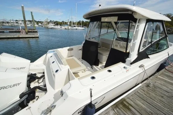 Slide: The Image of 2022 Boston Whaler 280 Vantage docked, showcasing sleek design and dual Mercury engines. - 2