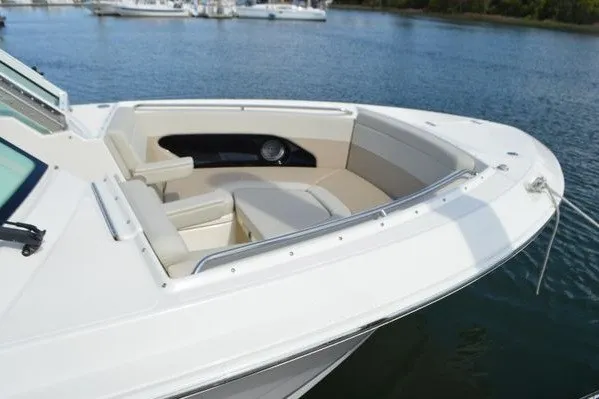 Slide: The Image of 2022 Boston Whaler 280 Vantage boat with spacious seating, docked on calm water. - 8