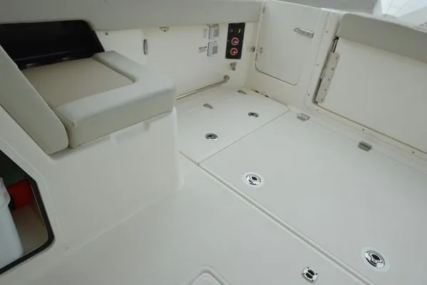 Slide: The Image of 2022 Boston Whaler 280 Vantage boat interior with seating and storage compartments. - 41