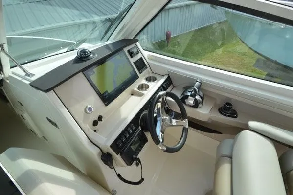 Slide: The Image of 2022 Boston Whaler 280 Vantage helm with modern navigation system and steering wheel. - 21
