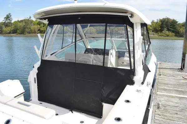 Slide: The Image of 2022 Boston Whaler 280 Vantage boat docked, featuring black canvas enclosure. - 14
