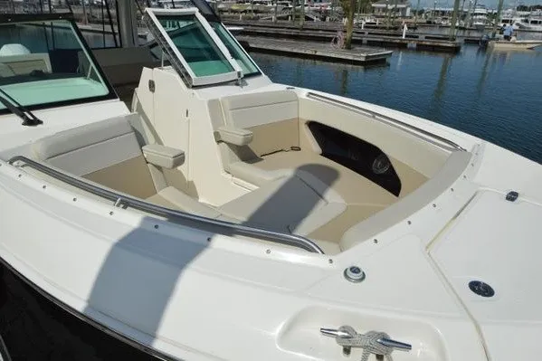Slide: The Image of 2022 Boston Whaler 280 Vantage boat with spacious seating at the marina. - 12