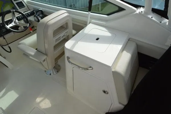Slide: The Image of 2022 Boston Whaler 280 Vantage boat interior with helm and seating area. - 24