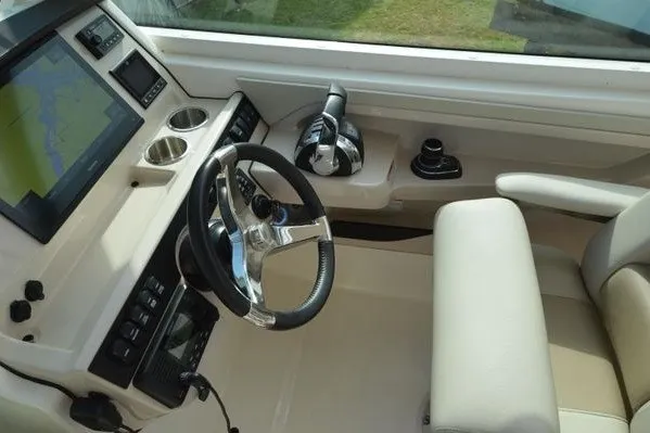 Slide: The Image of 2022 Boston Whaler 280 Vantage helm with steering wheel, controls, and navigation display. - 22