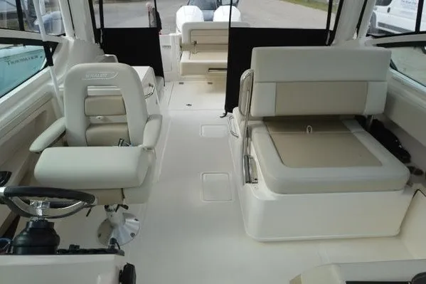 Slide: The Image of Interior of a 2022 Boston Whaler 280 Vantage boat, featuring comfortable seating and helm. - 32