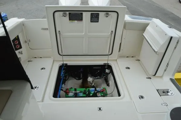 Slide: The Image of 2022 Boston Whaler 280 Vantage boat showing open engine compartment. - 40