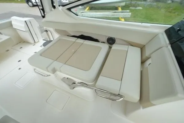 Slide: The Image of 2022 Boston Whaler 280 Vantage interior seating with beige cushions and sleek design. - 37