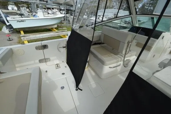 Slide: The Image of 2022 Boston Whaler 280 Vantage interior with seating and protective covers. - 36
