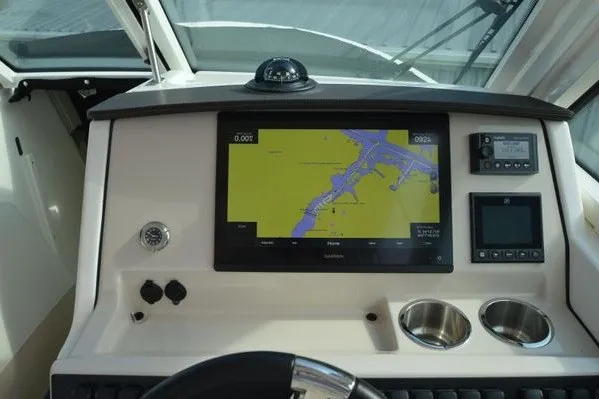 Slide: The Image of Dashboard of 2022 Boston Whaler 280 Vantage with navigation screen and controls. - 19