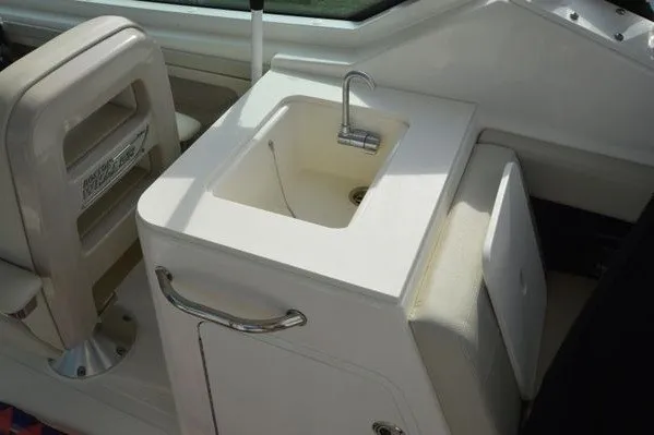 Slide: The Image of 2022 Boston Whaler 280 Vantage boat interior with sink and seating area. - 23