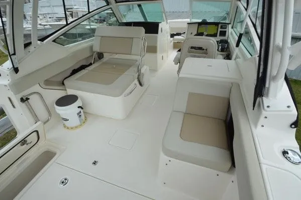 Slide: The Image of Interior of 2022 Boston Whaler 280 Vantage boat with beige seating and helm. - 43