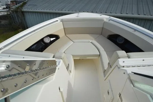 Slide: The Image of 2022 Boston Whaler 280 Vantage boat interior with cushioned seating and speakers. - 27