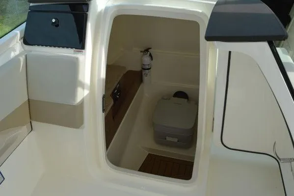 Slide: The Image of 2022 Boston Whaler 280 Vantage boat interior with compact toilet and fire extinguisher. - 25