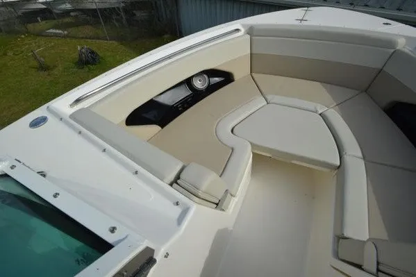 Slide: The Image of 2022 Boston Whaler 280 Vantage boat interior with beige seating and storage compartments. - 29