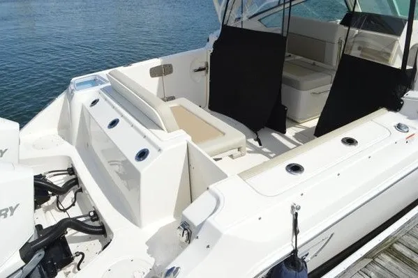 Slide: The Image of 2022 Boston Whaler 280 Vantage boat interior with seating and outboard motors. - 7