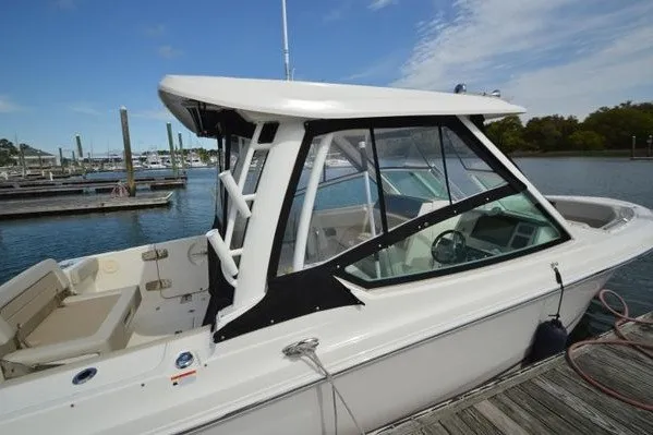 Slide: The Image of 2022 Boston Whaler 280 Vantage boat docked at marina, side view. - 6