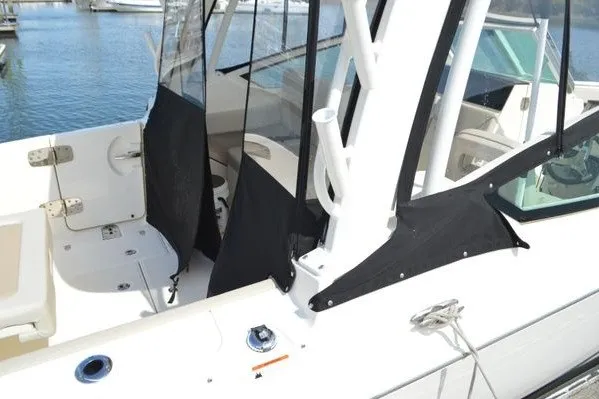 Slide: The Image of 2022 Boston Whaler 280 Vantage boat interior with seating and protective covers. - 10