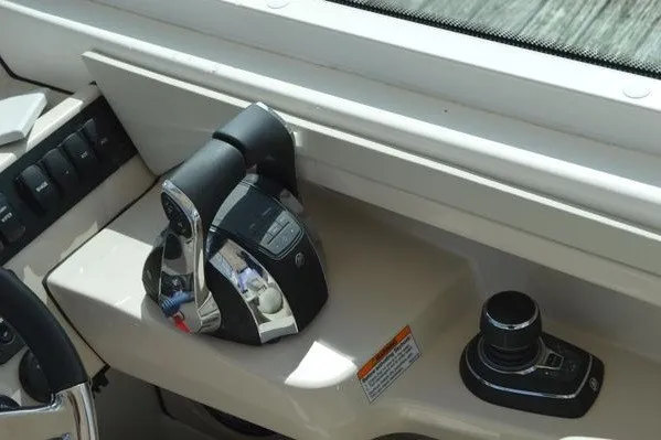 Slide: The Image of Control panel of 2022 Boston Whaler 280 Vantage boat, featuring throttle and joystick. - 11