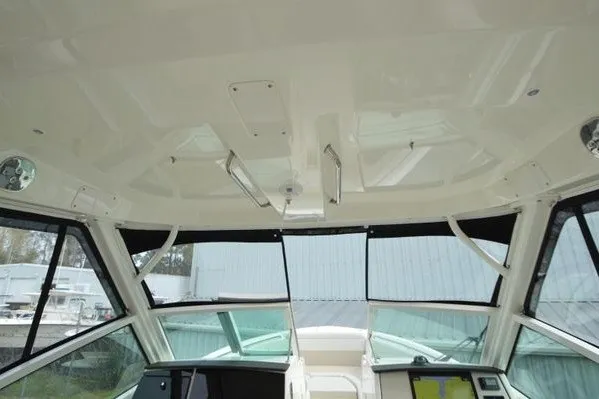 Slide: The Image of Interior view of 2022 Boston Whaler 280 Vantage boat, showcasing helm and windshield design. - 34