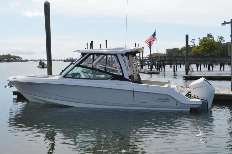 The Image of 2022 Boston Whaler 280 Vantage boat docked in a serene marina setting. - 0