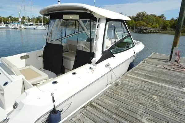 Slide: The Image of 2022 Boston Whaler 280 Vantage docked at a marina, showcasing sleek design and spacious interior. - 17