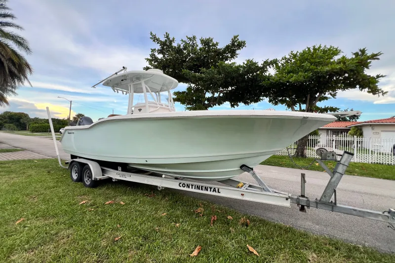 Slide: The Image of 2015 Tidewater 250 CC Adventure boat on trailer, parked on grass by roadside. - 9