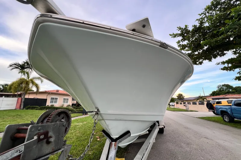 Slide: The Image of 2015 Tidewater 250 CC Adventure boat on trailer, residential street background. - 6