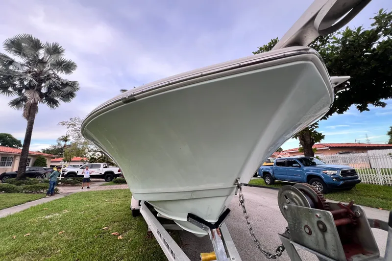 Slide: The Image of 2015 Tidewater 250 CC Adventure boat on trailer, parked in residential area. - 8