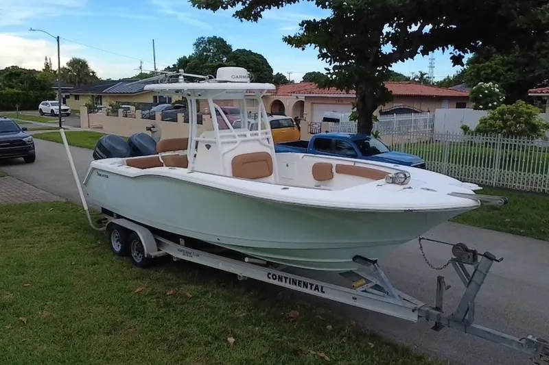 Slide: The Image of 2015 Tidewater 250 CC Adventure boat on trailer in suburban neighborhood. - 1