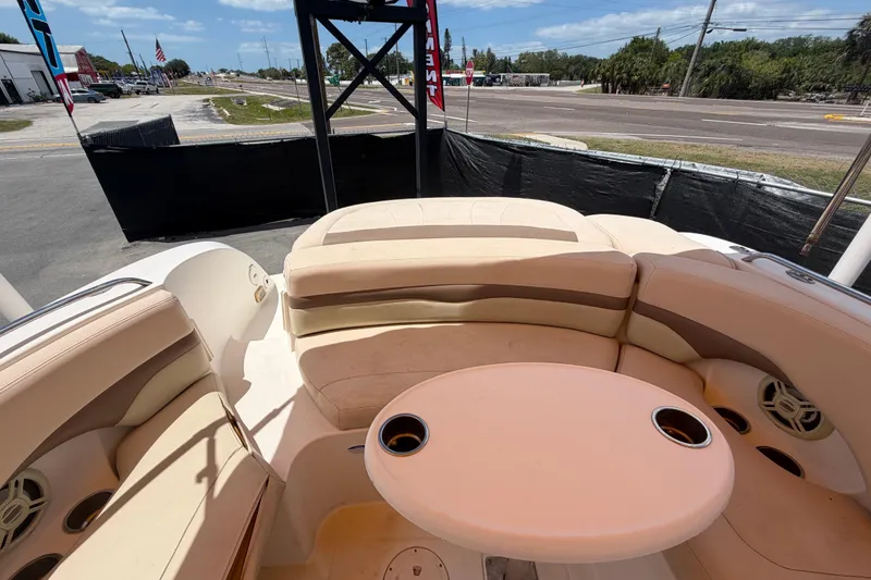 Slide: The Image of 2006 Chaparral Sunesta 236 boat interior with beige seating and round table. - 81