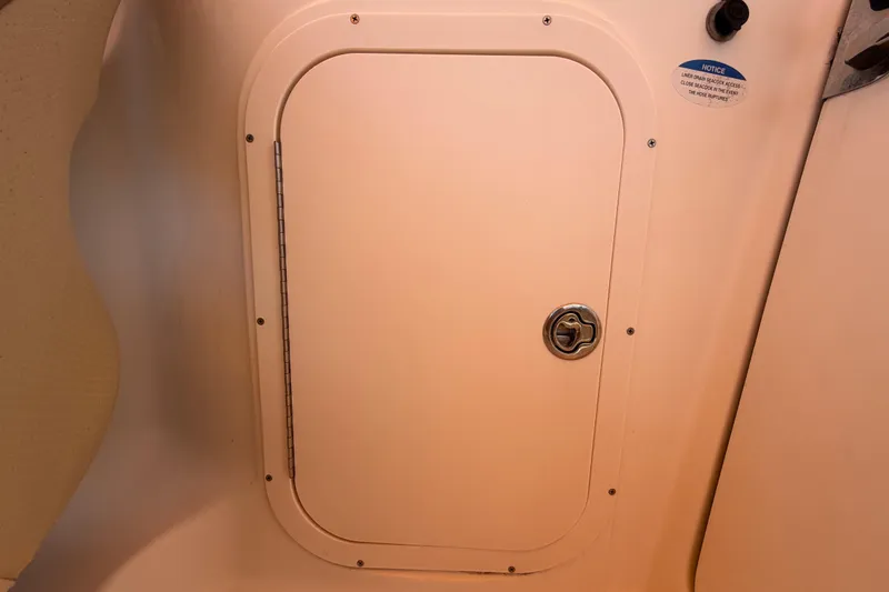 Slide: The Image of 2006 Chaparral Sunesta 236 boat storage compartment with secure latch. - 40