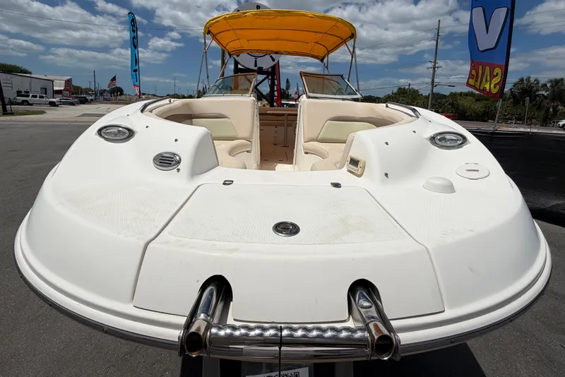 Slide: The Image of 2006 Chaparral Sunesta 236 boat with yellow canopy, displayed outdoors under a cloudy sky. - 11