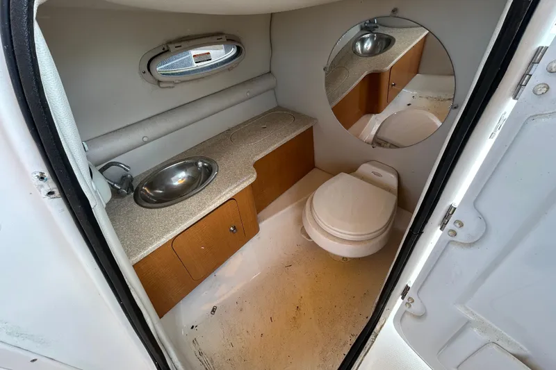 Slide: The Image of 2006 Chaparral Sunesta 236 boat bathroom with sink, toilet, and mirror. - 50