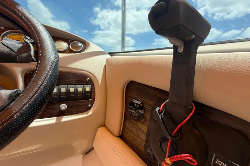 Slide: The Image of 2006 Chaparral Sunesta 236 dashboard with steering wheel and control panel under blue sky. - 32