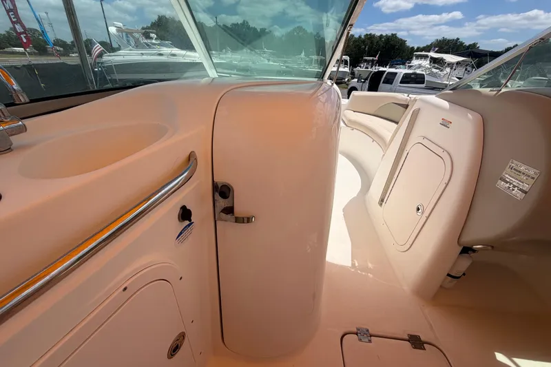 Slide: The Image of 2006 Chaparral Sunesta 236 boat interior with seating and storage compartments. - 47