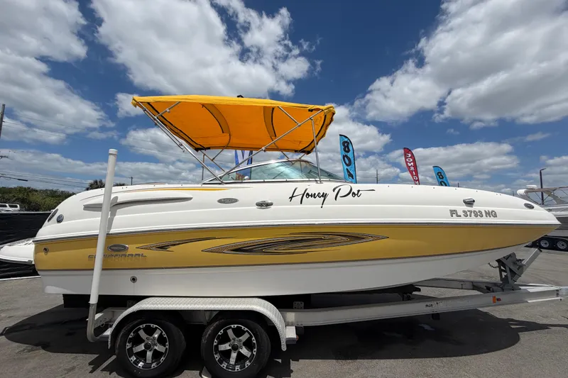 Slide: The Image of 2006 Chaparral Sunesta 236 boat with yellow canopy on trailer under blue sky. - 1
