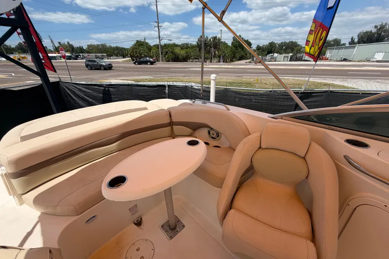 Slide: The Image of 2006 Chaparral Sunesta 236 boat interior with beige seating and round table. - 80