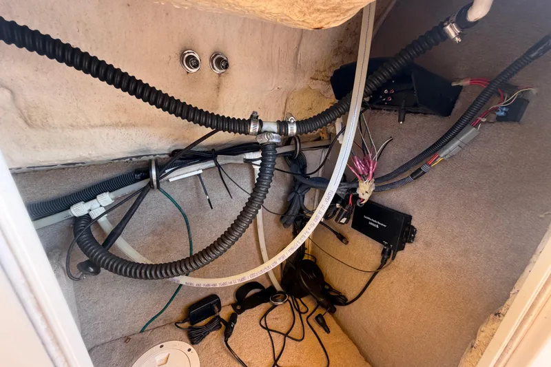 Slide: The Image of Electrical wiring and components inside a 2006 Chaparral Sunesta 236 boat compartment. - 42